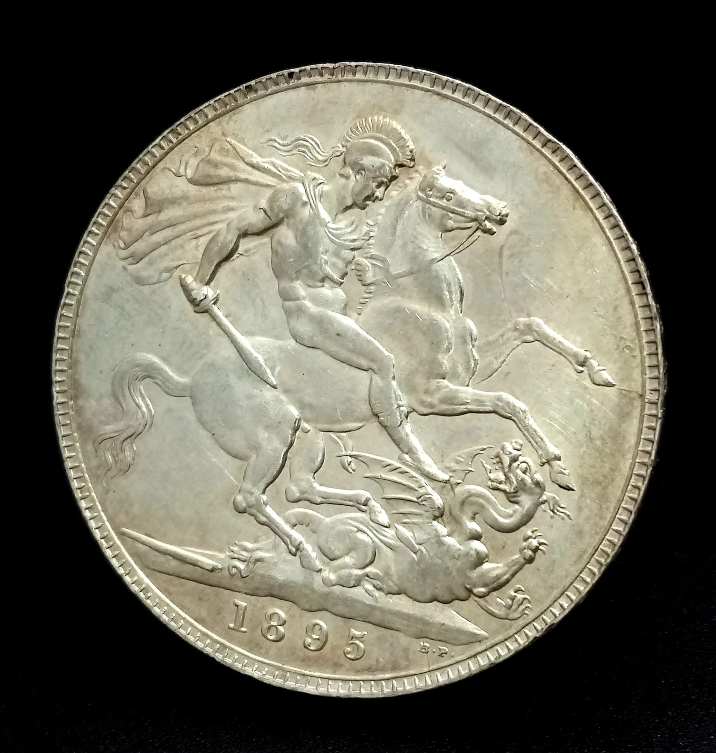 An 1895 Queen Victoria Silver Crown Coin. Old head. EF/UNC, thus rare.