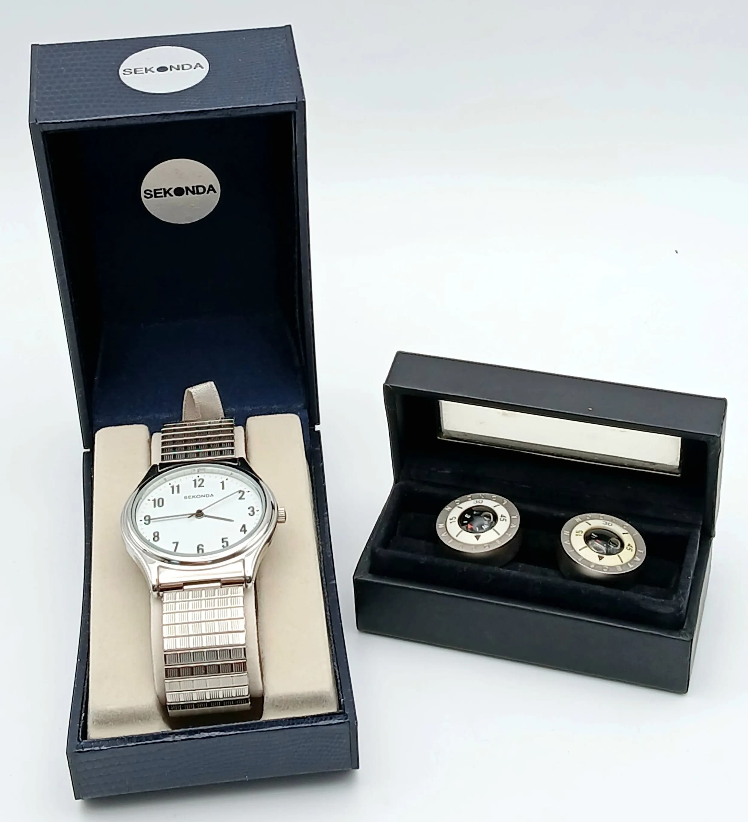 A Men’s Stainless Steel Sekonda Dress Watch and Compass Cufflinks Combination. The Watch measures 36mm including the Crown and has had the original battery replaced in July 2026. Comes on a flex strap and is in its original box. The Cufflinks are made by Tateossian, London and measures 2cm Diameter.