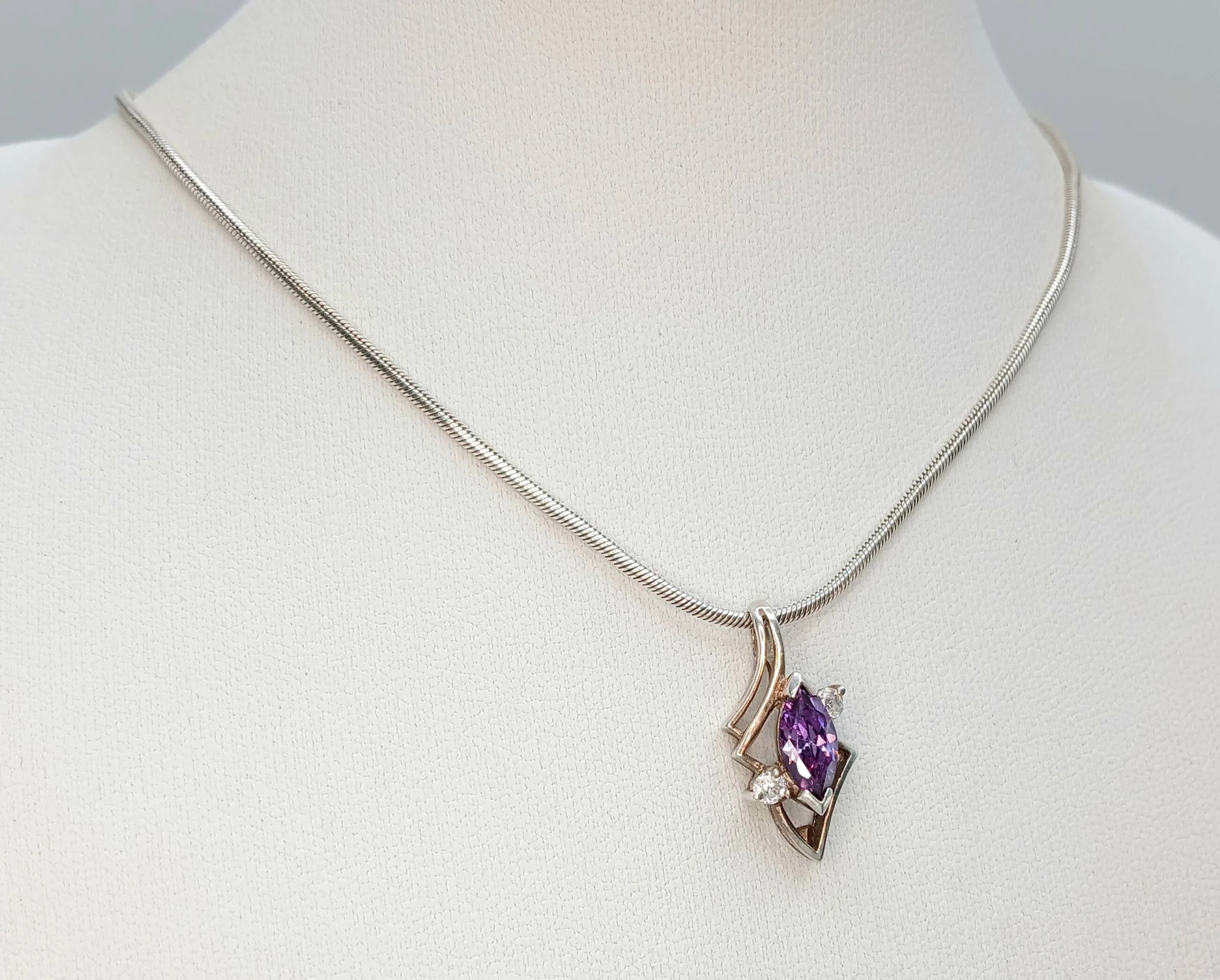 A Pretty 925 Sterling Silver Amethyst and CZ Pendant Necklace – 39cm Length. The pendant is set with a marquise-cut purple amethyst and CZ stone accents in a decorative geometric setting. The pendant measures 2.3cm x 1cm. Gross weight 7.27 grams.