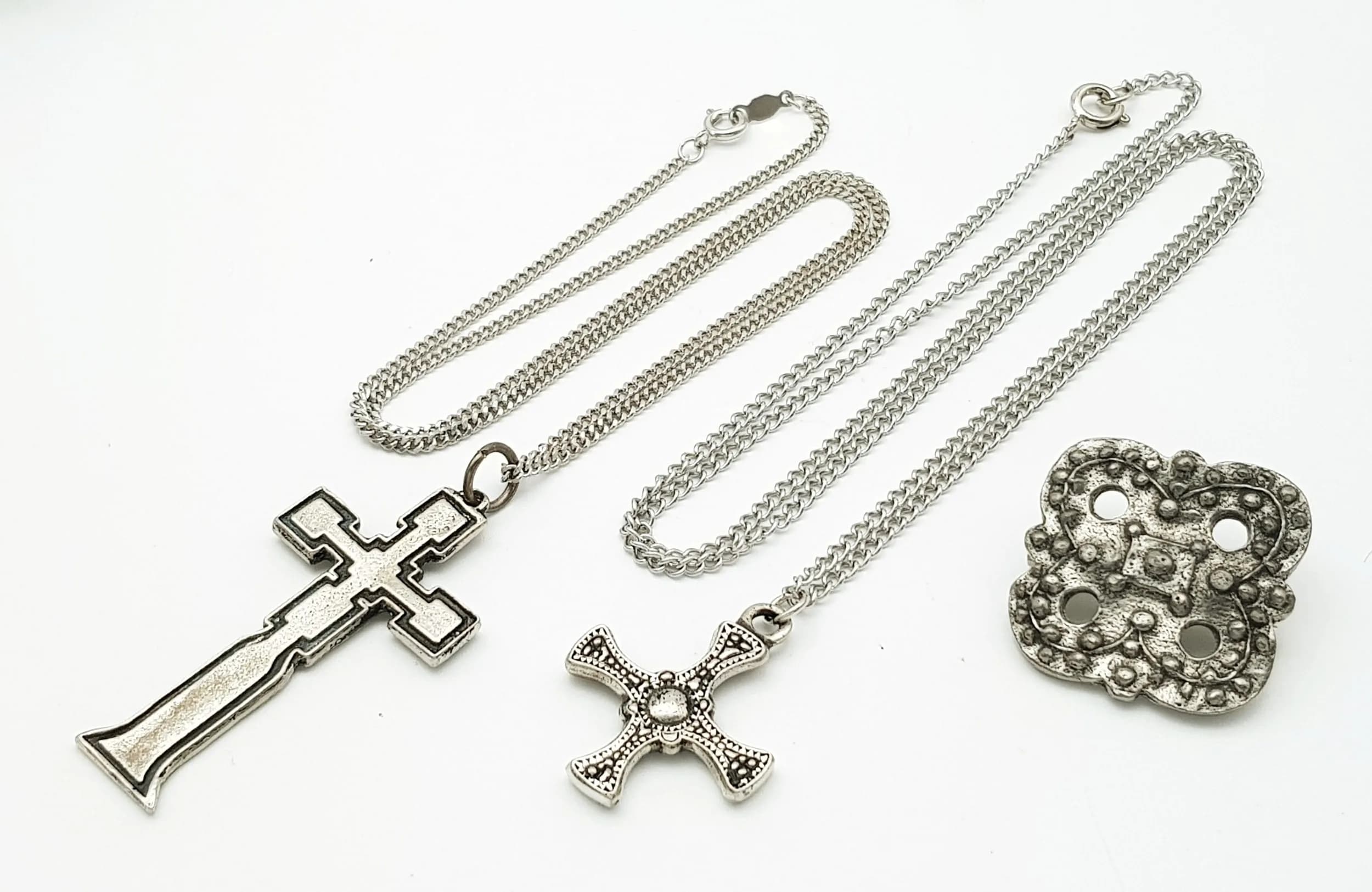 A Parcel of Three Boxed Cornish Celtic St. Justin Pewter Jewellery Pieces. Comprising: 1) A Celtic Long Cross Pendant Necklace-46cm Length Chain. Cross measures 5cm drop. 2) A Celtic Cross Pendant Necklace-60cm length Chain. Cross measures 3cm Drop and 3) A Celtic Brooch-3cm Wide.