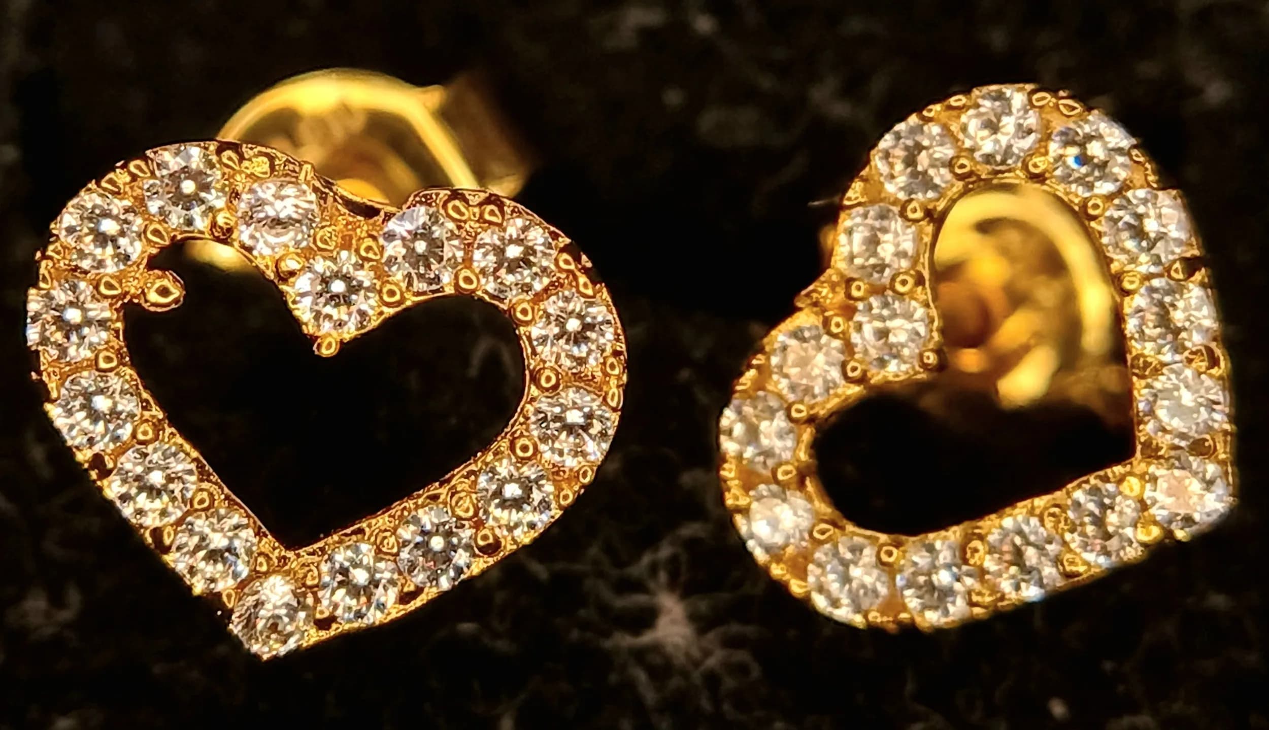 A Pretty Pair of 14K Yellow Gold Crystal Set Heart Stud Earrings-0.8cm x 0.8cm. Each Earring is designed as an open heart set with round cut clear crystals. The Earrings have a gross weight of 1.35 grams. Come with a presentation box.