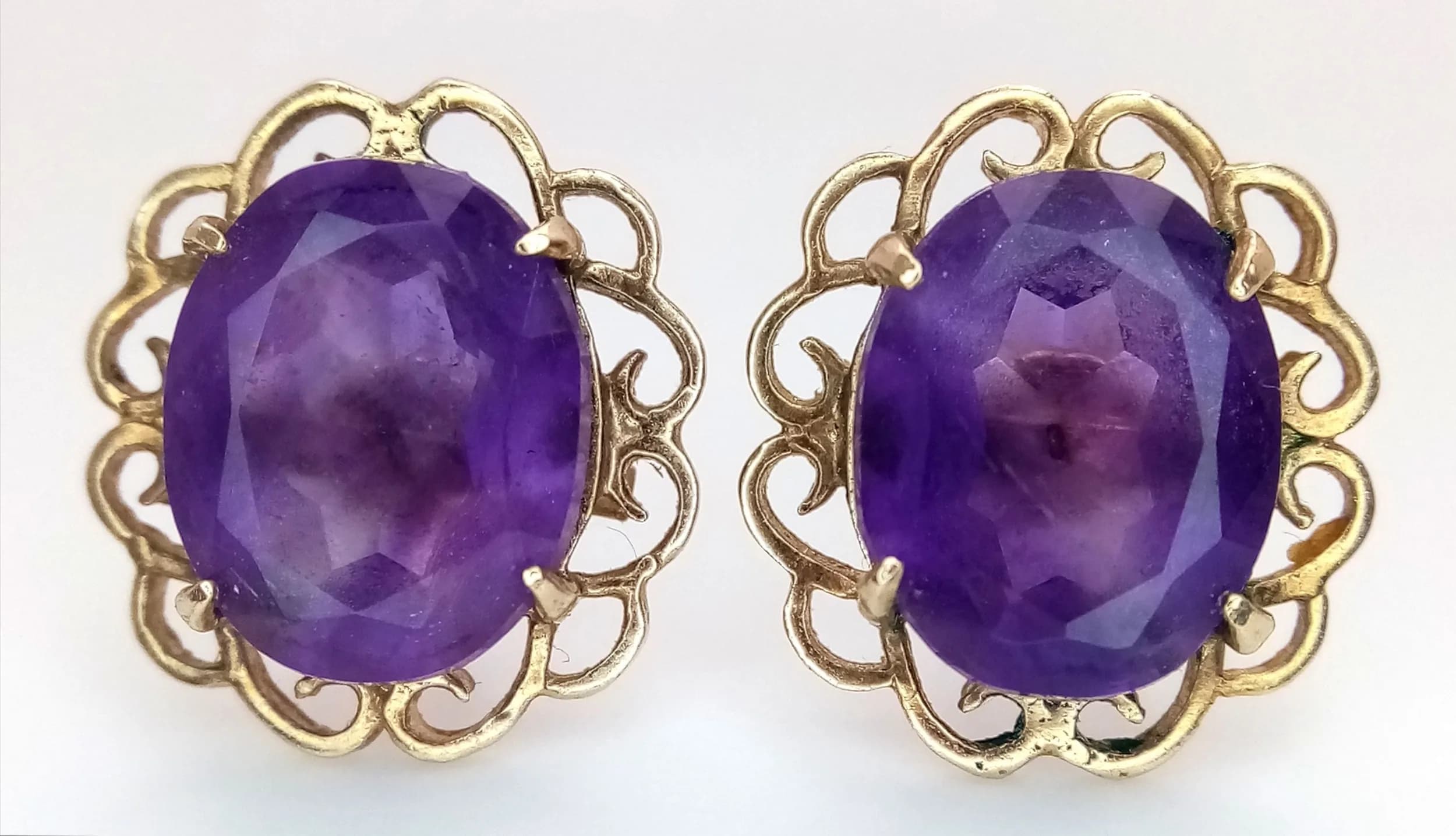 A Pair of Antique Style 9K Gold and Amethyst Stud Earrings.15mm. 2.8g total weight. No backs.