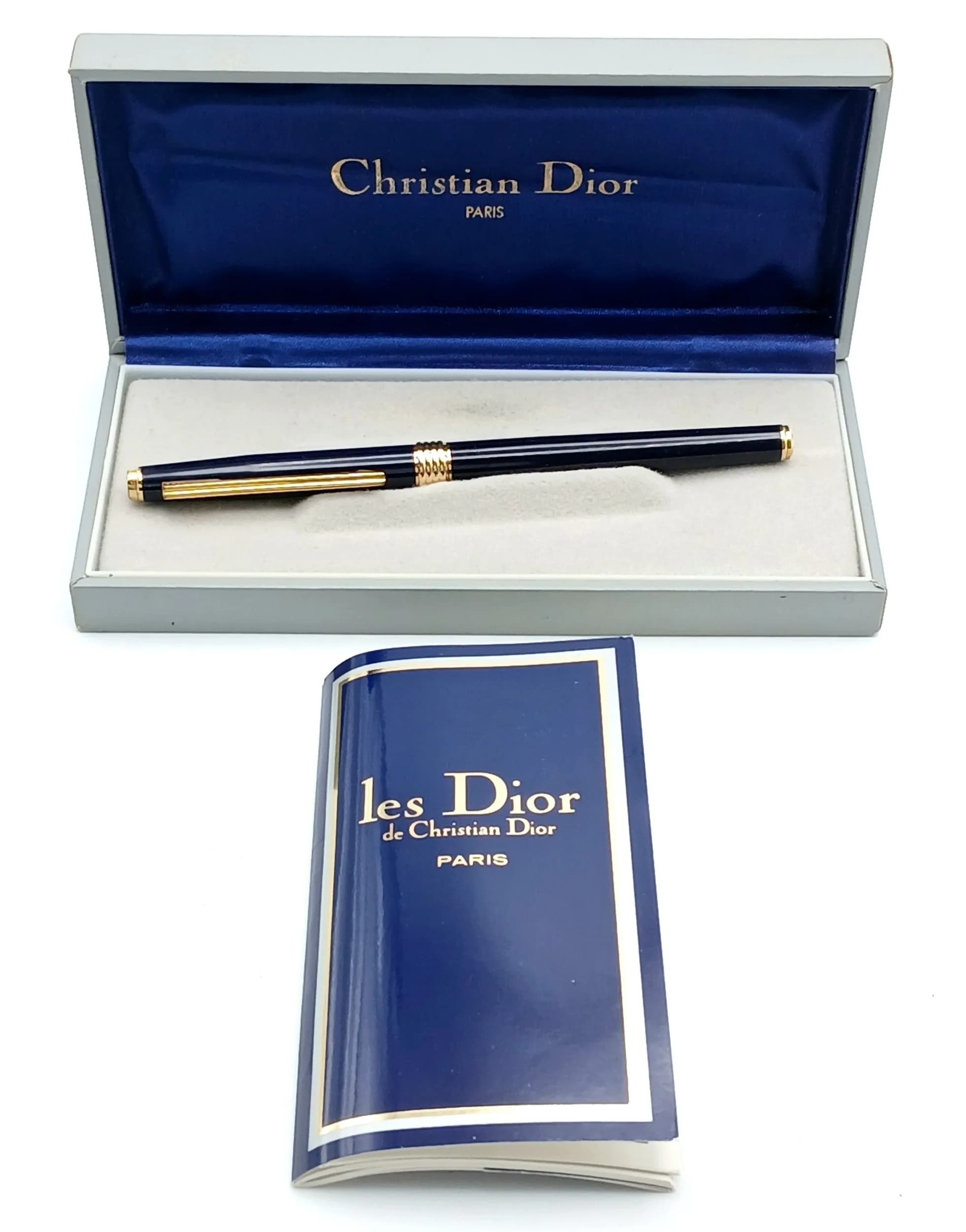 A Christian Dior Paris Blue Lacquer and Gold Tone Fountain Pen. 15cm Length. The Pen comes with spare cartridges and an ink filling system for bottled ink. Complete with box and papers.
