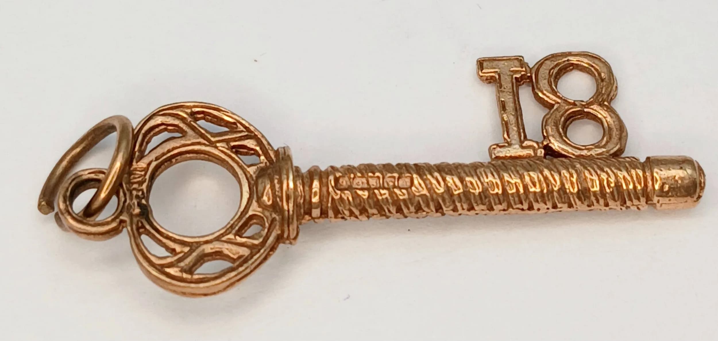 A 9K Yellow Gold '18' Key Pendant. 3.5cm. 1.9g.