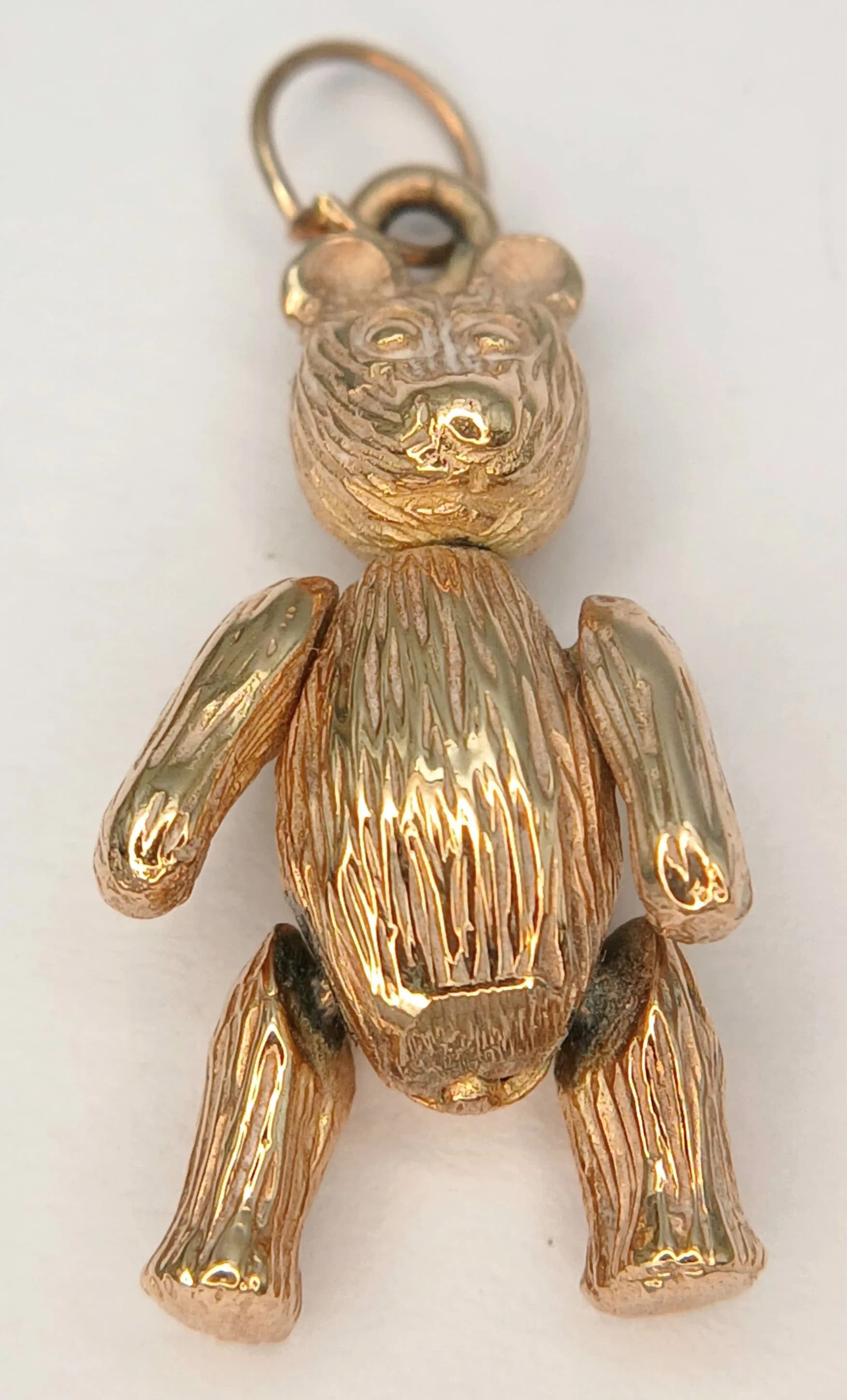 A 9K Yellow Gold Articulated Teddy Bear Pendant. 2.5cm. 3.8g.