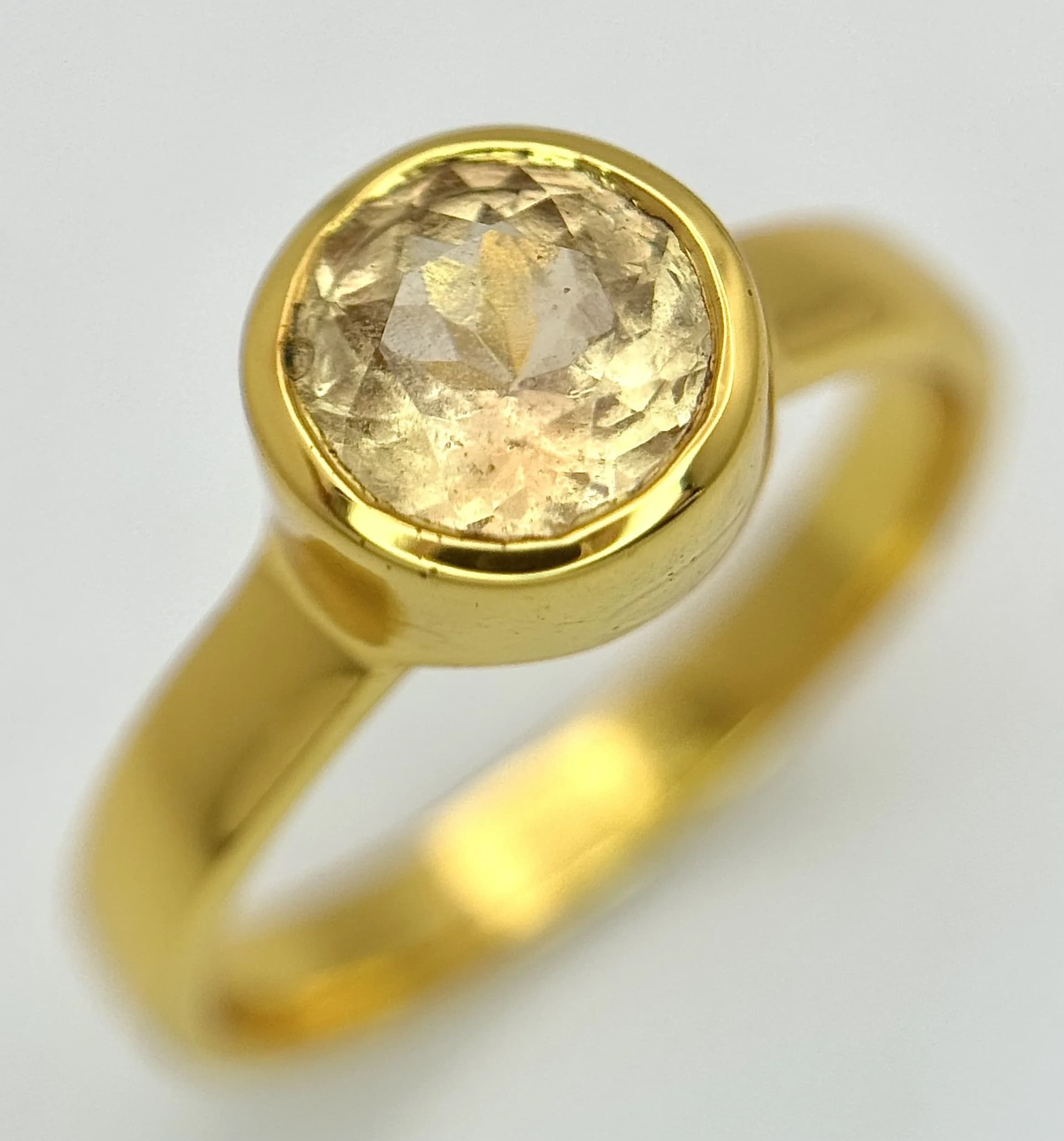 A Gold Gilded Sterling Silver Contemporary Design Citrine Solitaire Ring Size N1/2. The Ring is set with a 7mm faceted round cut Citrine, approximately 1.25 carat. Gross weight 3.05 grams.