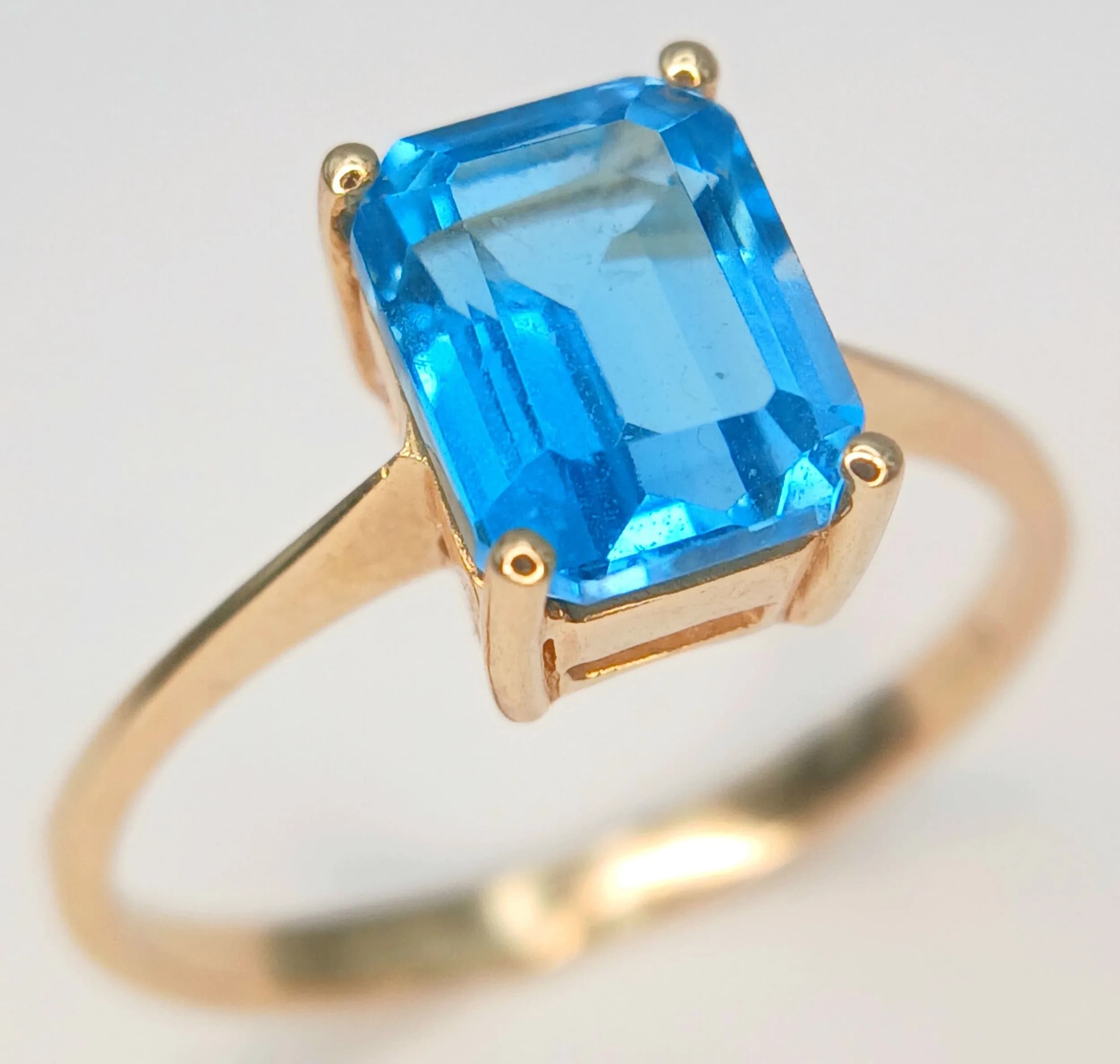 A 14K Yellow Gold, London Topaz Solitaire Ring. Size M 1/2. 2g total weight. 1.5ct emerald cut topaz.