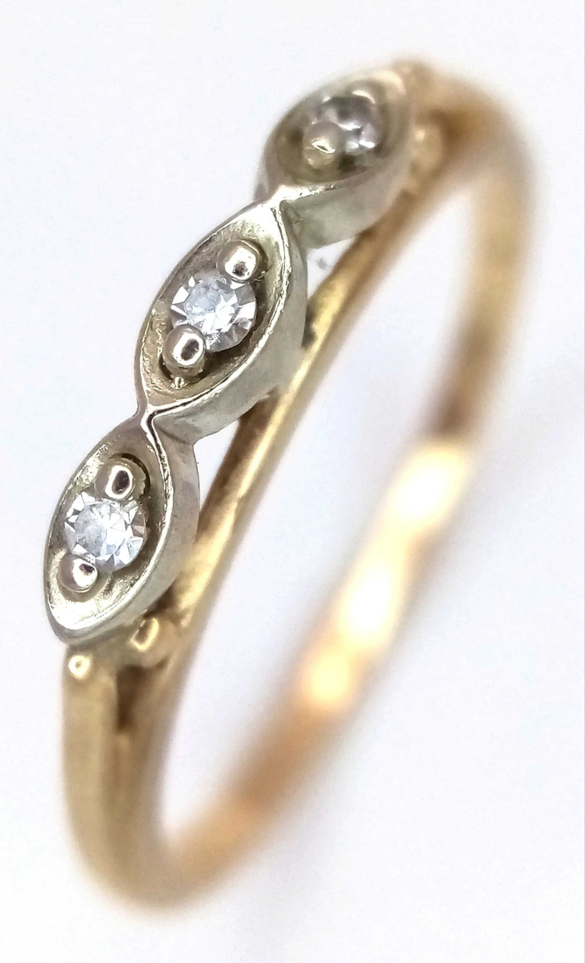 A 14K Yellow Gold Three Stone Diamond Ring. Size L 1/2. 1.7g total weight.