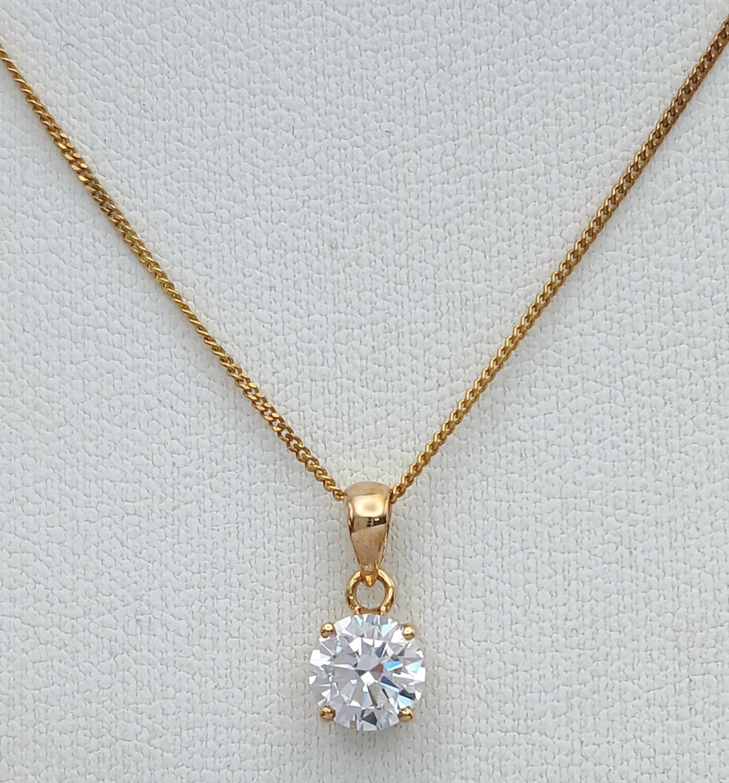 A 9k Yellow Gold Cubic Zirconia Solitaire Pendant Necklace-41cm length chain, the pendant is set with a 6mm Round Cut Vibrant Cubic Zirconia. Gross Weight 1.44 Grams.