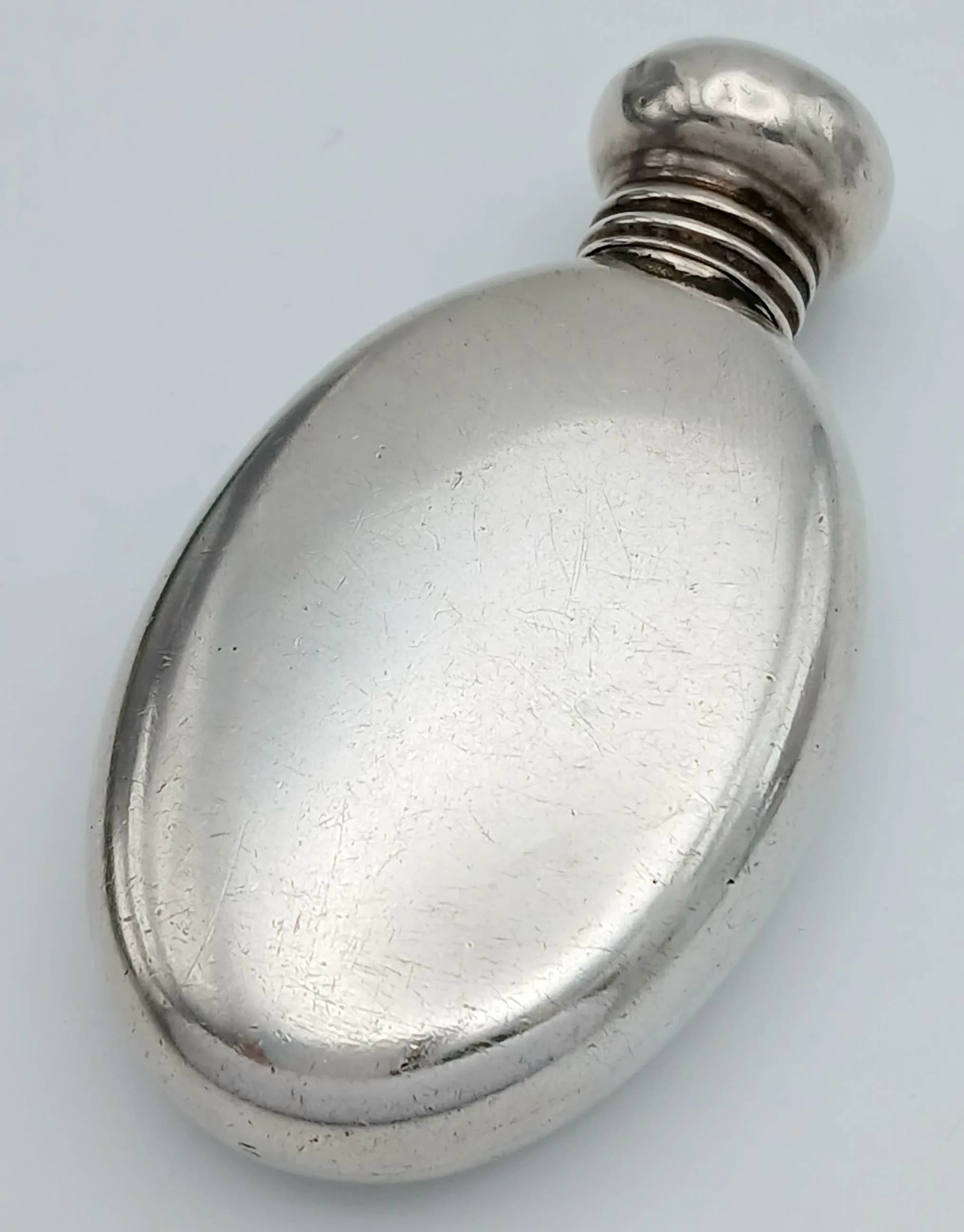 An Antique Small Sterling Silver Oval Perfume Bottle. 5cm. 14g. Birmingham 1912 hallmarks.