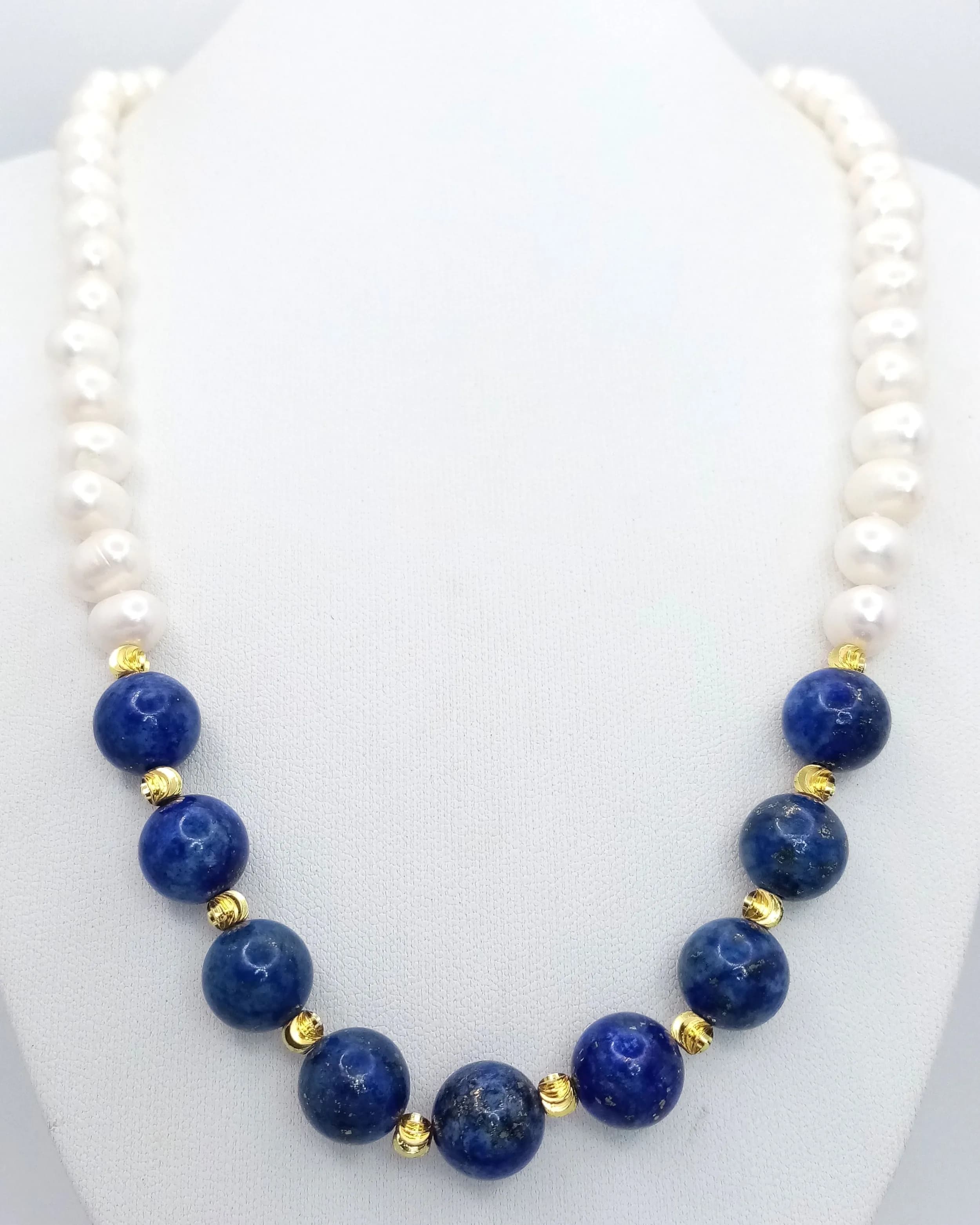 A Freshwater Pearl and Lapis Lazuli Beaded Necklace. 6/7mm pearls. 12mm lapis. 42cm necklace length.