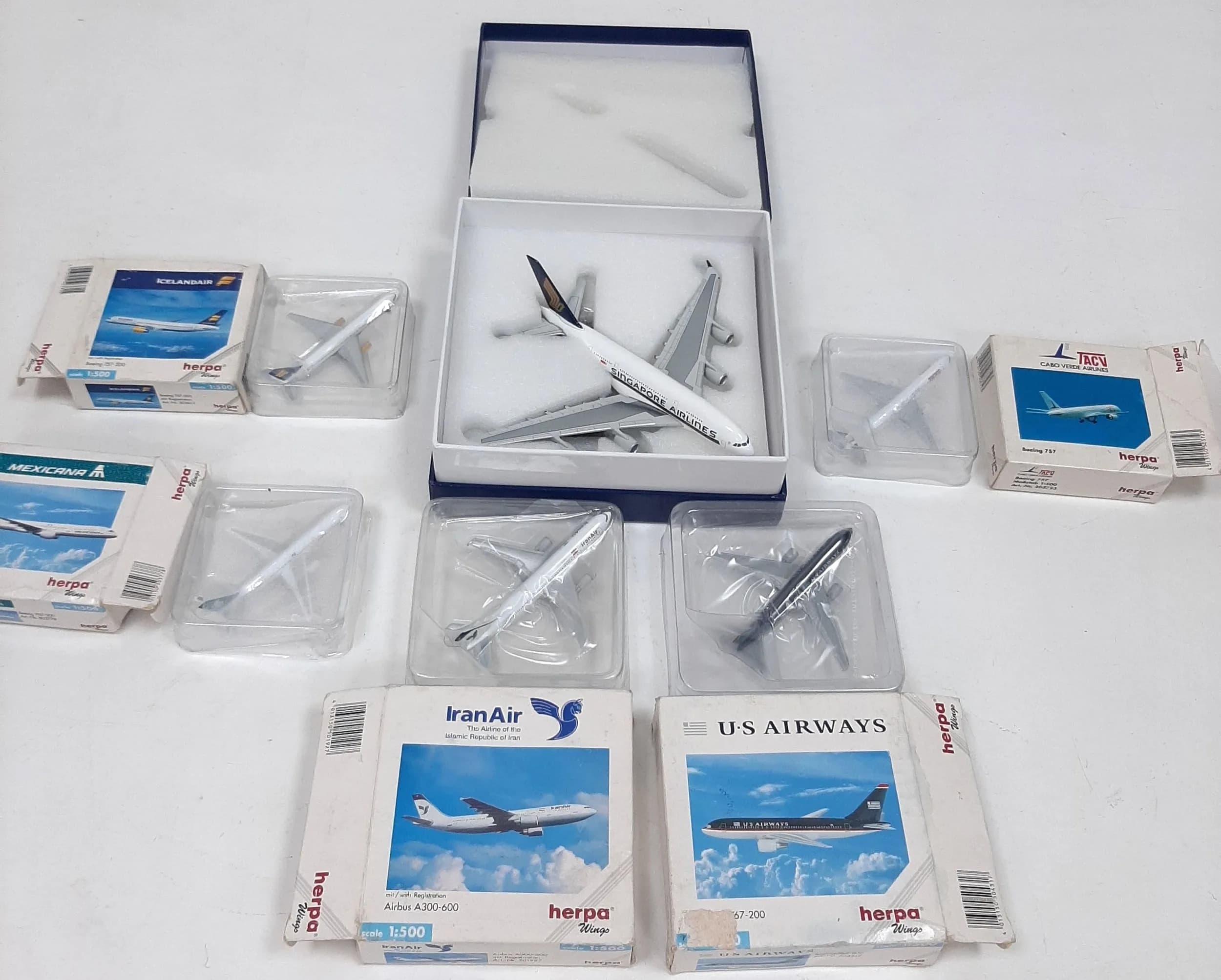 Six die cast model commercial aeroplanes. To include a Singapore airlines Airbus A380-800, 1/400 scale and five Herpa 1/500 scale planes including a Boeing 757-200, a Boeing 757, a Boeing 757-200, a Boeing 767-200 and an Airbus A300-600. All in very good condition, these have never been out of their boxes on display.