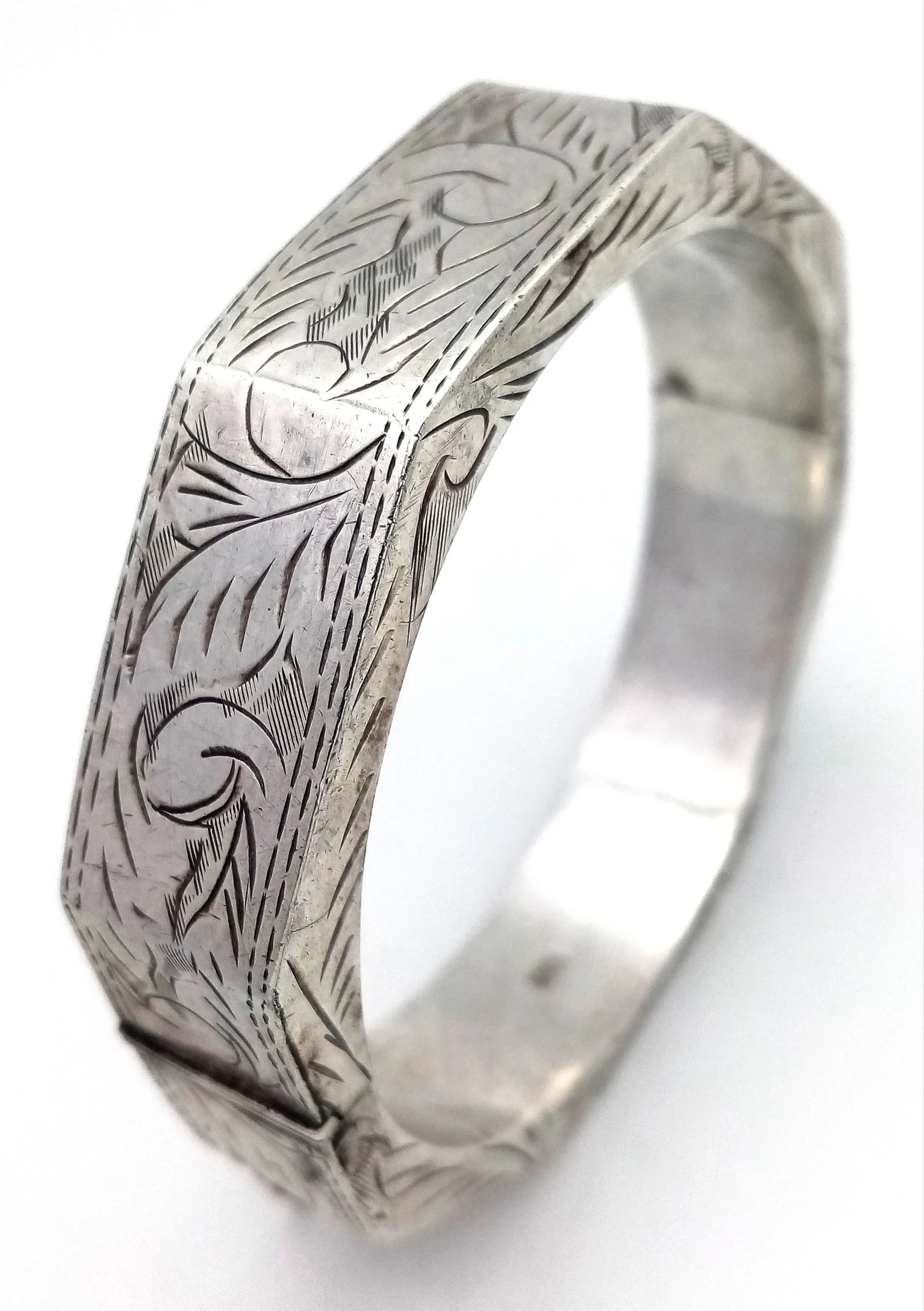 A Vintage Octagonal Sterling Silver Bangle. 15mm width. Clip open design with safety chain. 35g