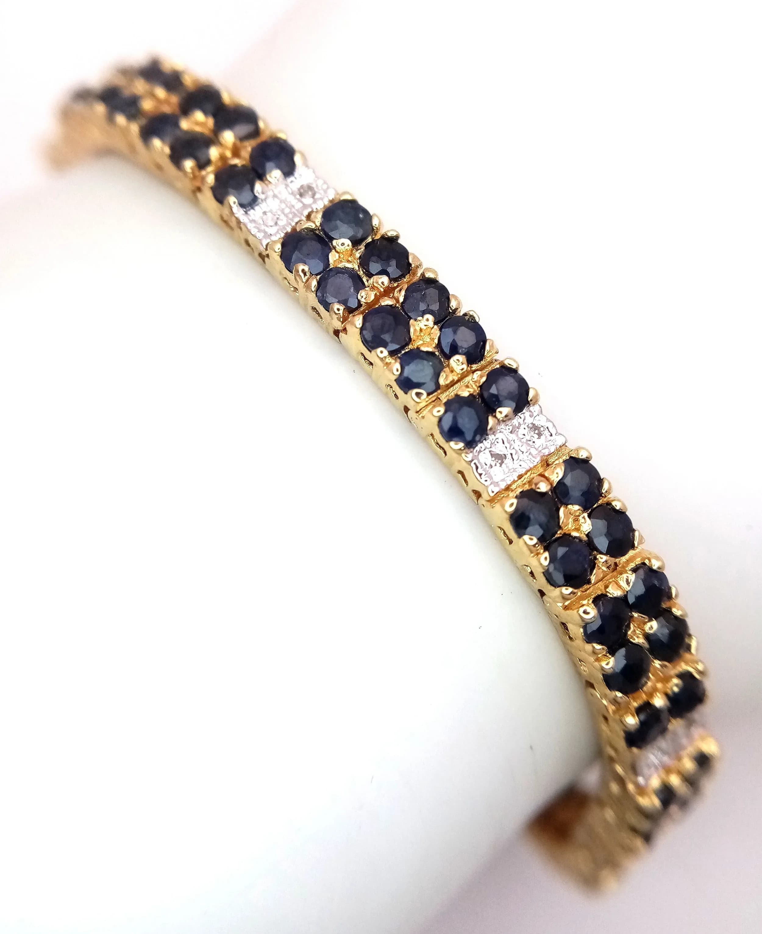A VERY PRETTY GOLD PLATED SILVER DIAMOND AND SAPPHIRE BRACELET . 19.2gms 19cms