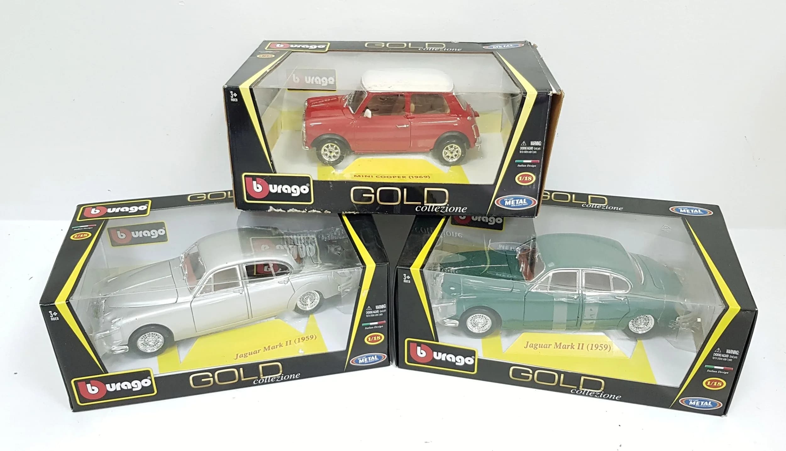 Three 1/18th scale die cast cars by Burago. Two Jaguars & a Mini. Good condition. Some wear to boxes from storage.