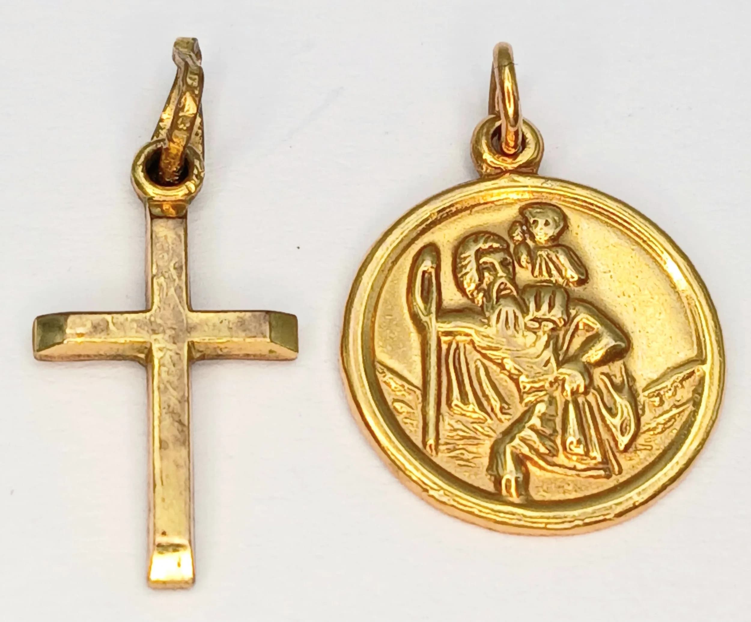 A 9K Yellow Gold Double Insurance Pendant Package. Cross and St. Christopher. 1.8g total weight.