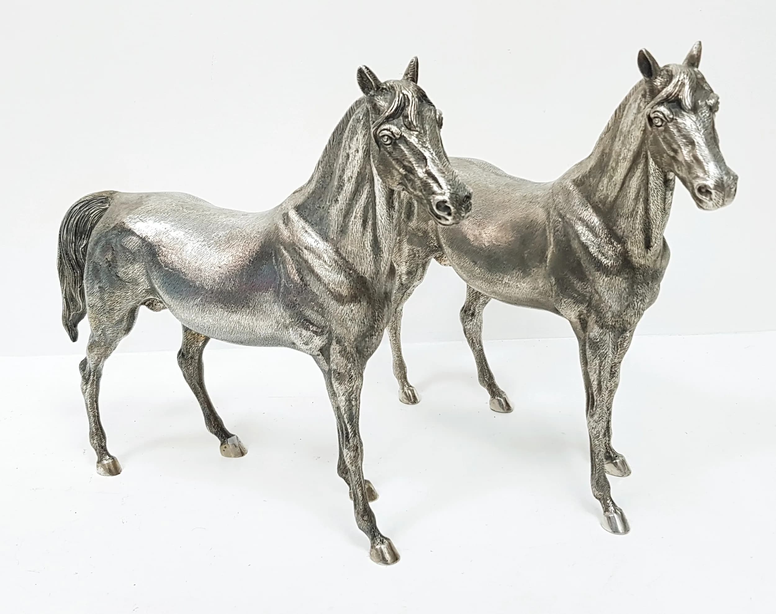 A Stunning Pair of Large 20th Century Silver Spanish Thoroughbreds. Circa 1950. 45cm length, 35cm height to top of ears. 4.3kg total weight. Winning bidder must collect from Cadmore HQ or arrange a courier service.