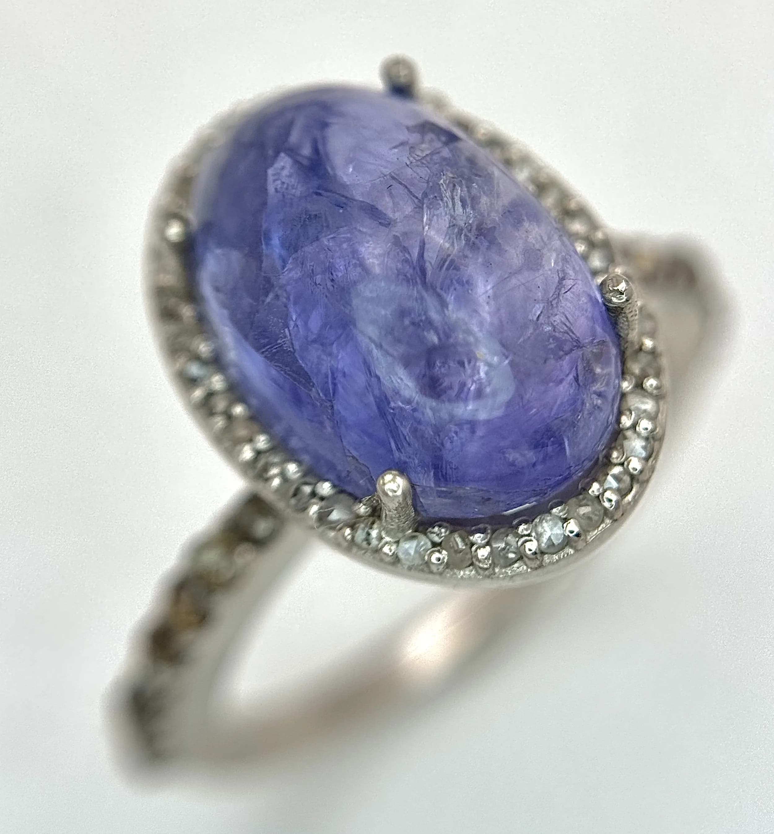 A 6.35ct Tanzanite Cabochon Gemstone Ring with 0.40ctw Diamond Accents, set in 925 Silver. Size N 1/2. CD-2143