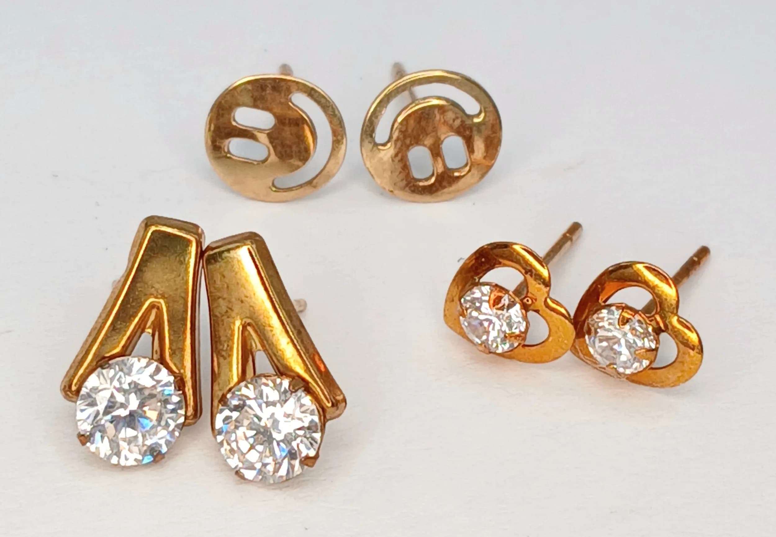 Three Different Style Pairs of 9K Gold Earrings. 1.35g total weight.