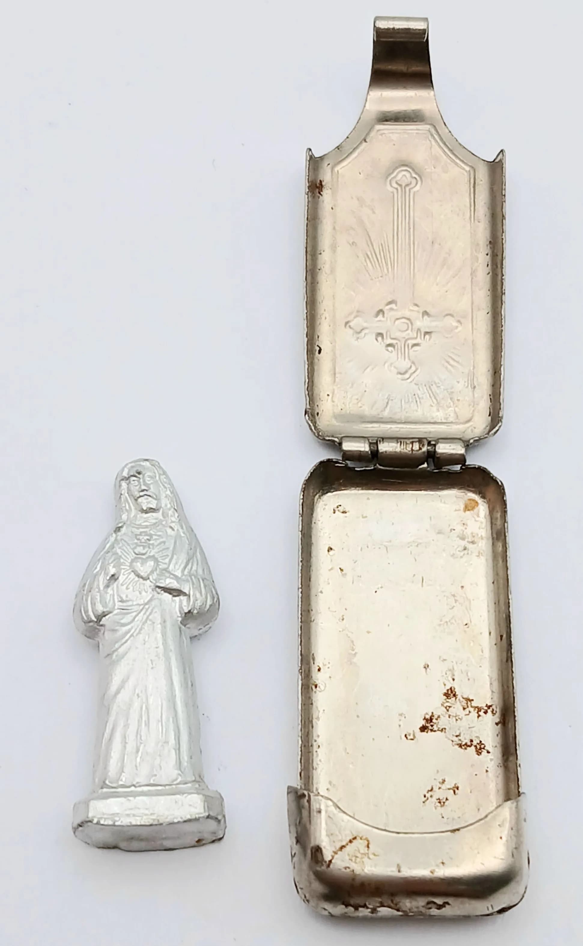 A Vintage, Possibly Antique German Silver-Tone Catholic Pocket Shrine. Cross and sunburst design on exterior with a religious figure inside, once opened. 3.5cm.