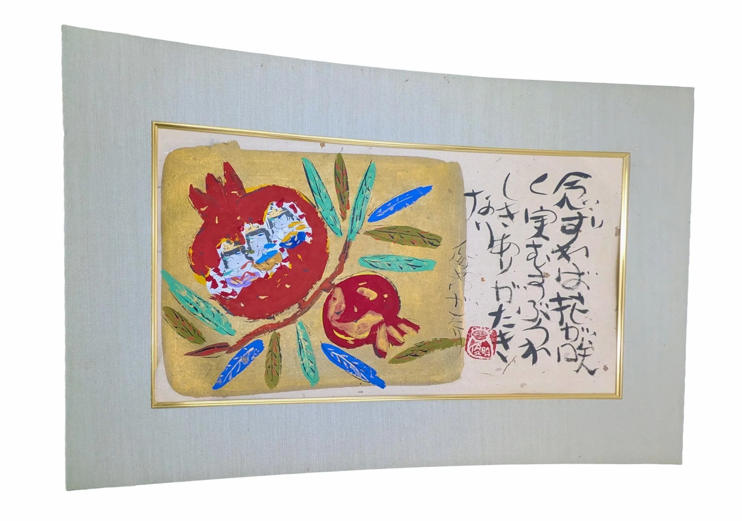 A Japanese Pomegranate and Calligraphy Picture. Decorated with red pomegranates, colourful leaves and Japanese calligraphy with red seal mark, framed and glazed. Approx 47.3cm x 25.9cm.