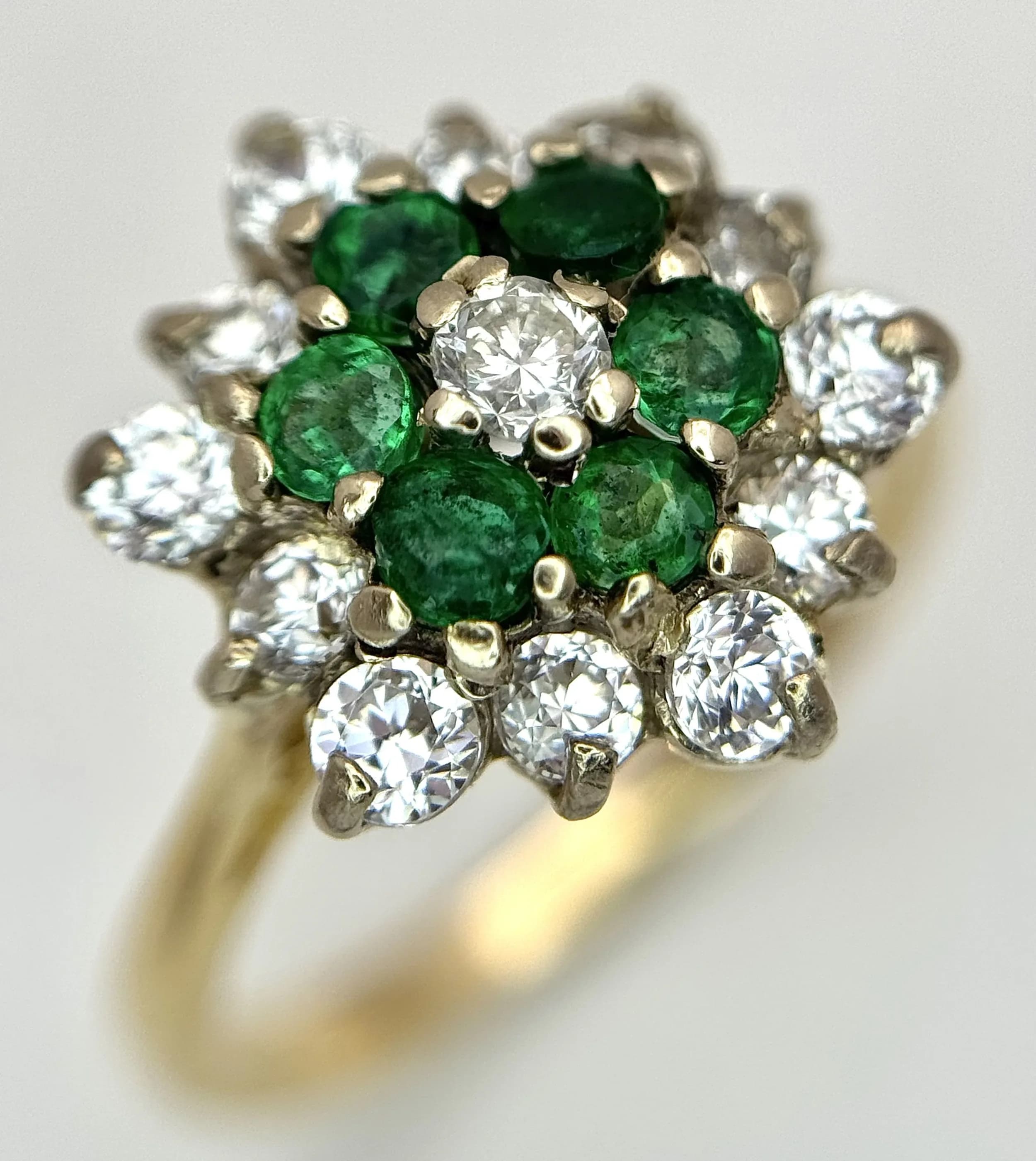 An 18K Yellow Gold, Diamond and Emerald Cluster Ring