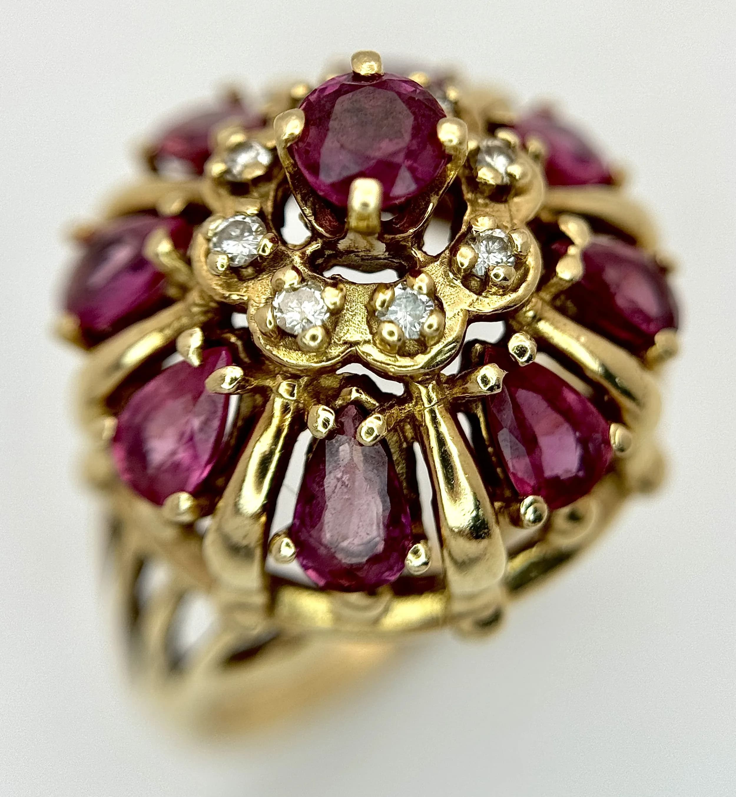 A Regal, 14K Yellow Gold, Purple Sapphire and Diamond Cluster Ring