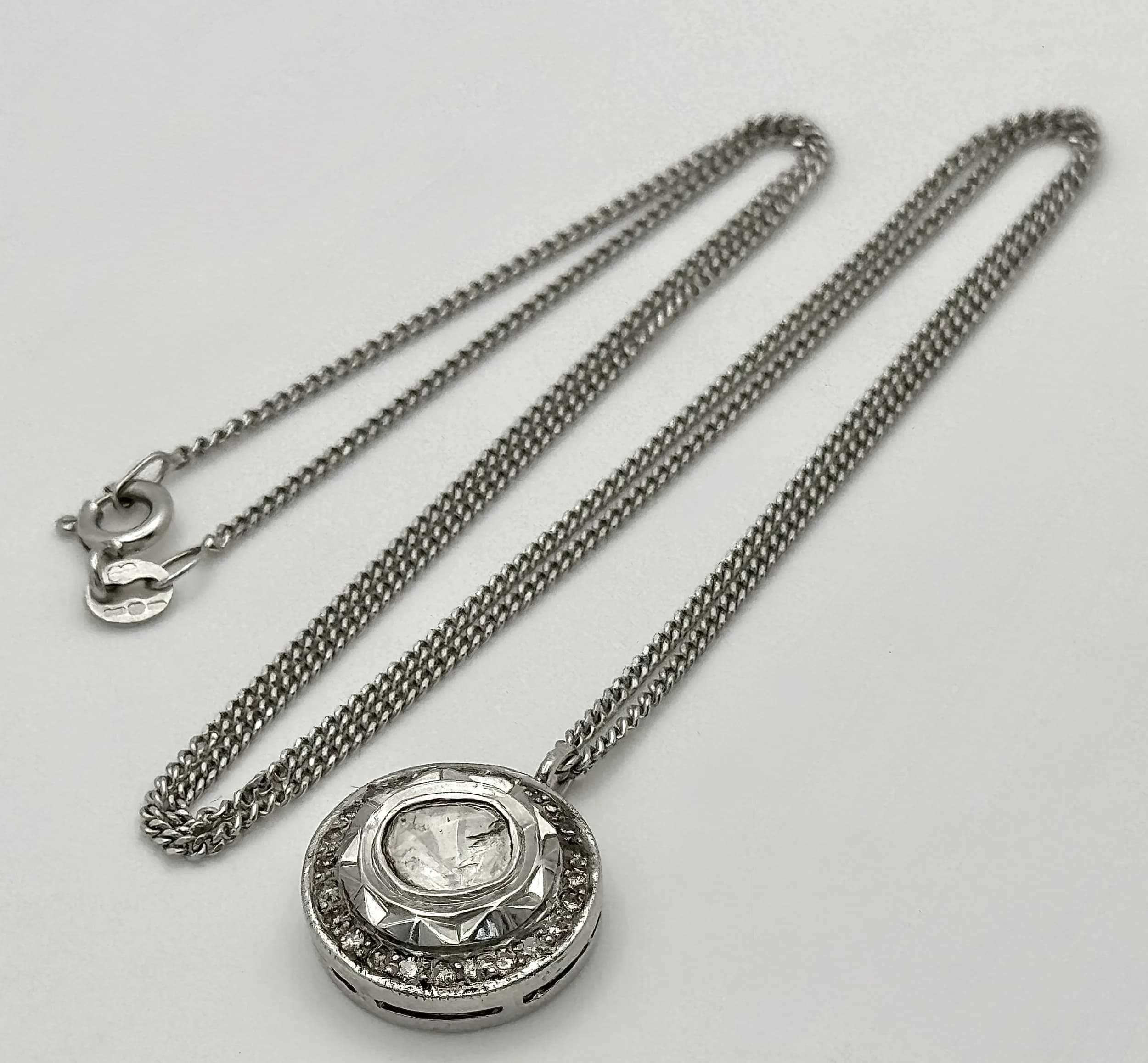 A Platinum 0.5ct Centre Diamond Halo Pendant on a 9K White Gold Chain Necklace